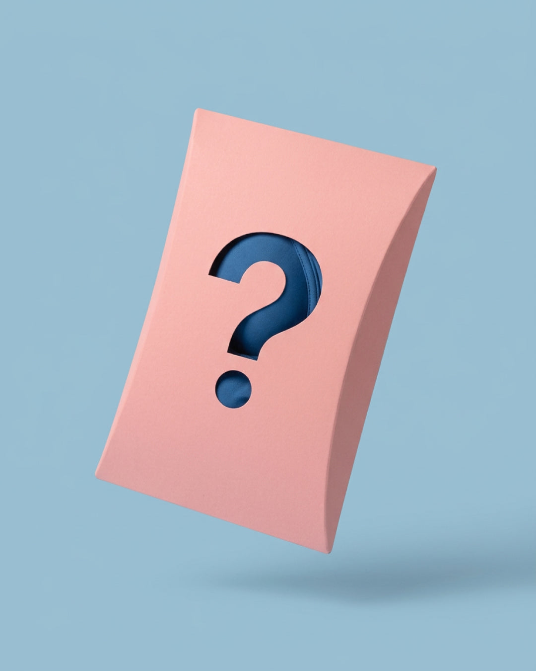 Pink mystery bra package with question-mark cutout revealing blue wireless bra fabric inside.