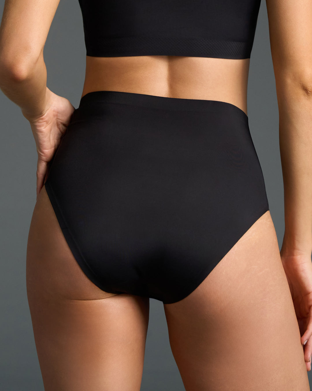 Black seamless high-waisted panties with a smooth wide waistband.