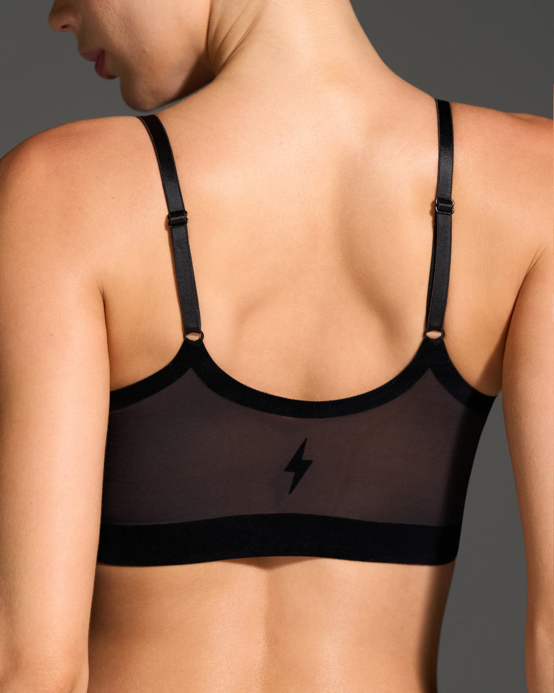 Back view of model wearing pearl support bralette with adjustable straps.