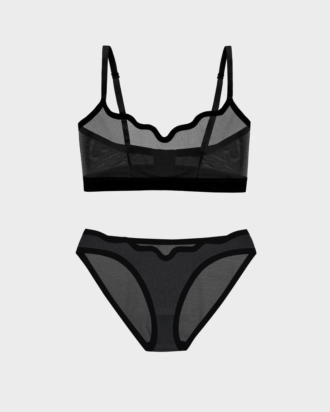 Lucy sheer black mesh wireless bra with matching bikini bottom on grey background.