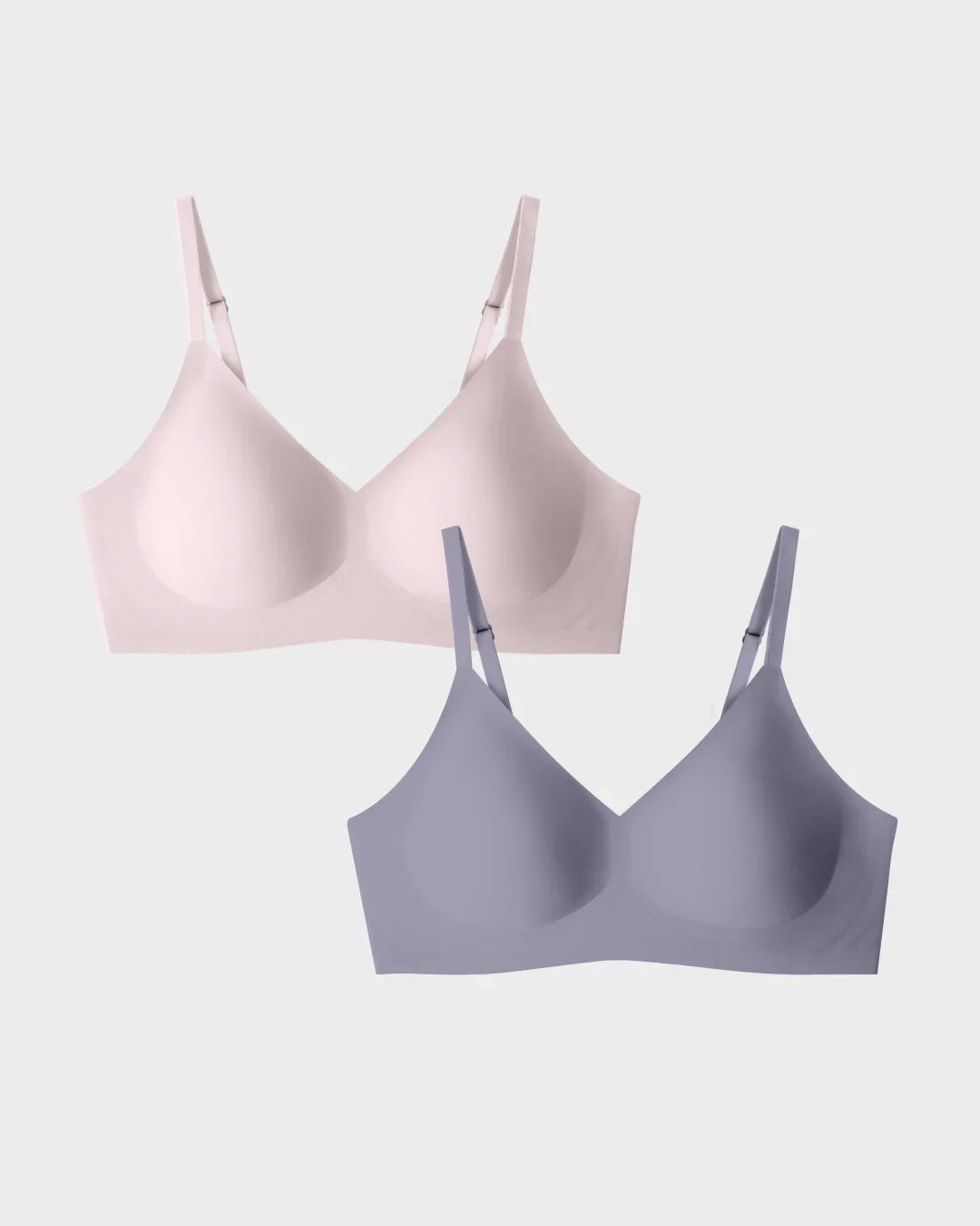 Seamless wireless bra two-pack in blush and slate grey with V-neckline and smooth molded cups.