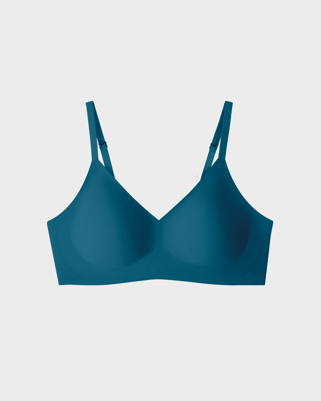 Teal seamless wireless Relief Bra with adjustable straps, shown flat on light background.