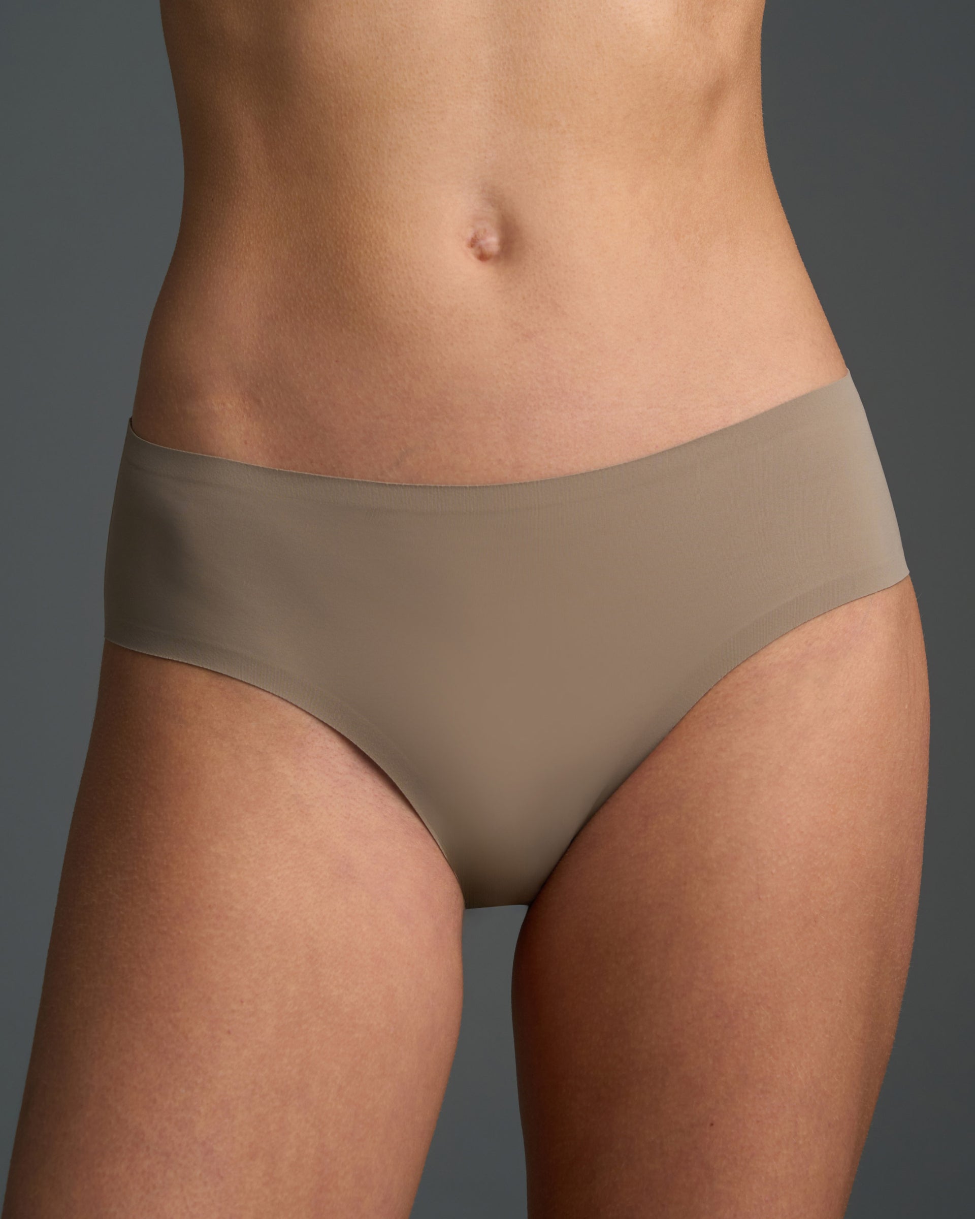 Model wears Fallen Rock seamless brief in taupe, showing smooth modest-rise coverage.