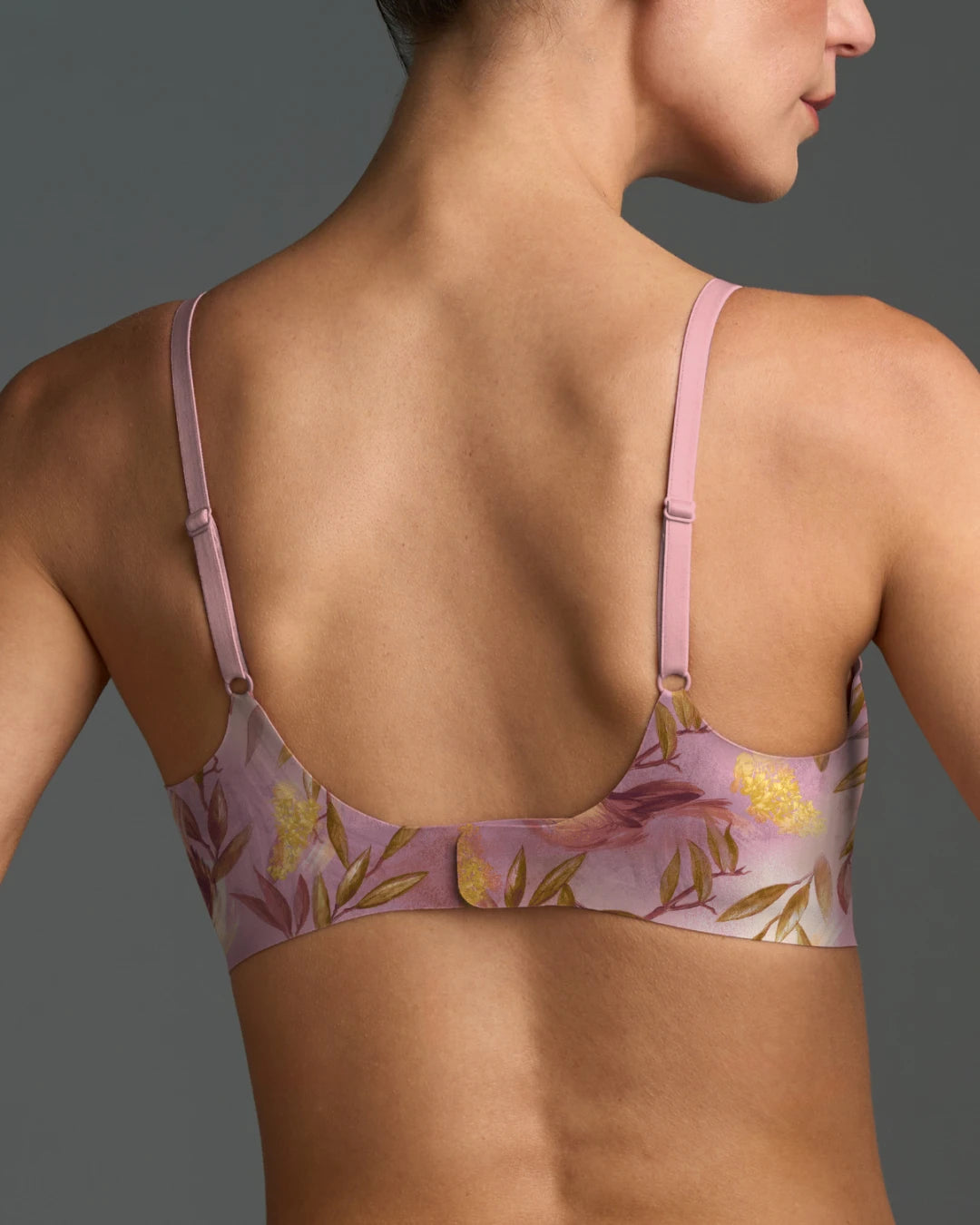Back view of Floret seamless wireless bra with pink floral print and adjustable straps.