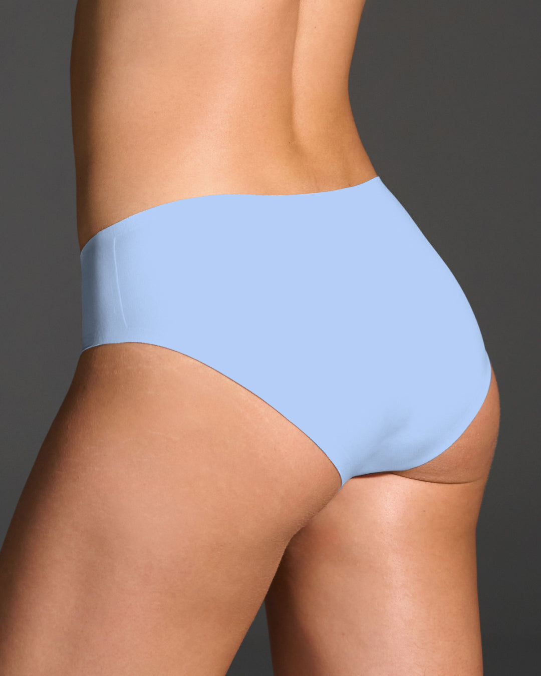 Back view of model wearing light blue Hydrangea seamless brief with full rear coverage.