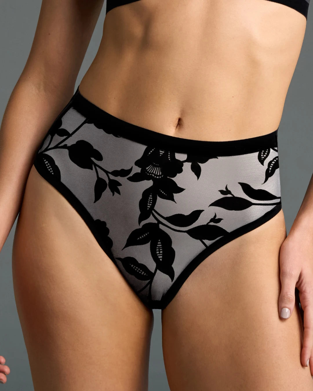 Madam Noir sheer high cut panty in black floral mesh, worn on model.