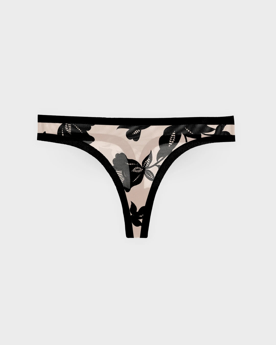 Madam Oh La La sheer mesh thong with black floral print on nude background.