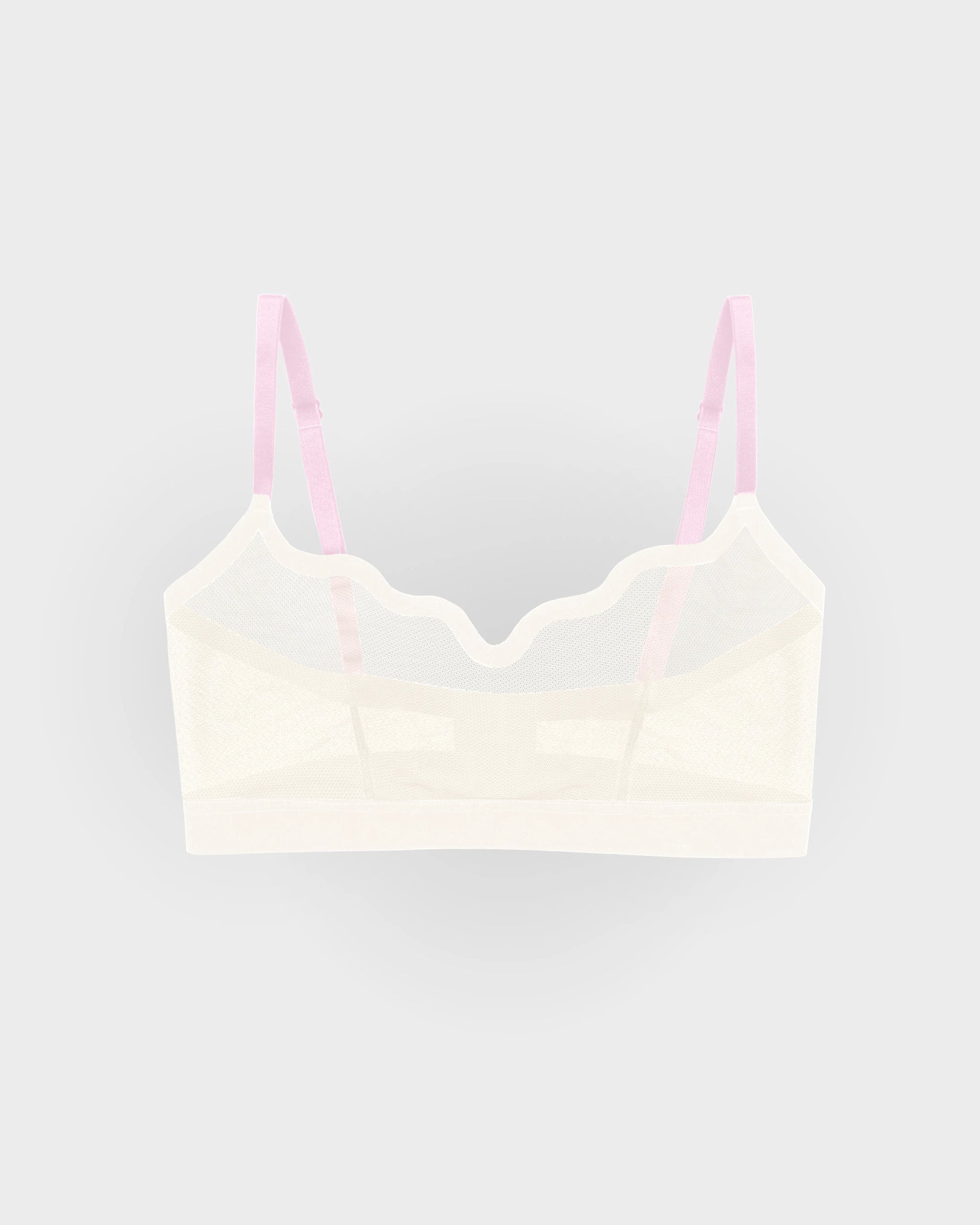 Cream sheer mesh Lucy bralette with scalloped neckline and pink adjustable straps, flat-lay.