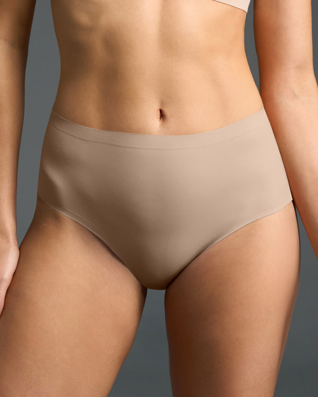Nude seamless high-waisted panties with a smooth wide waistband.