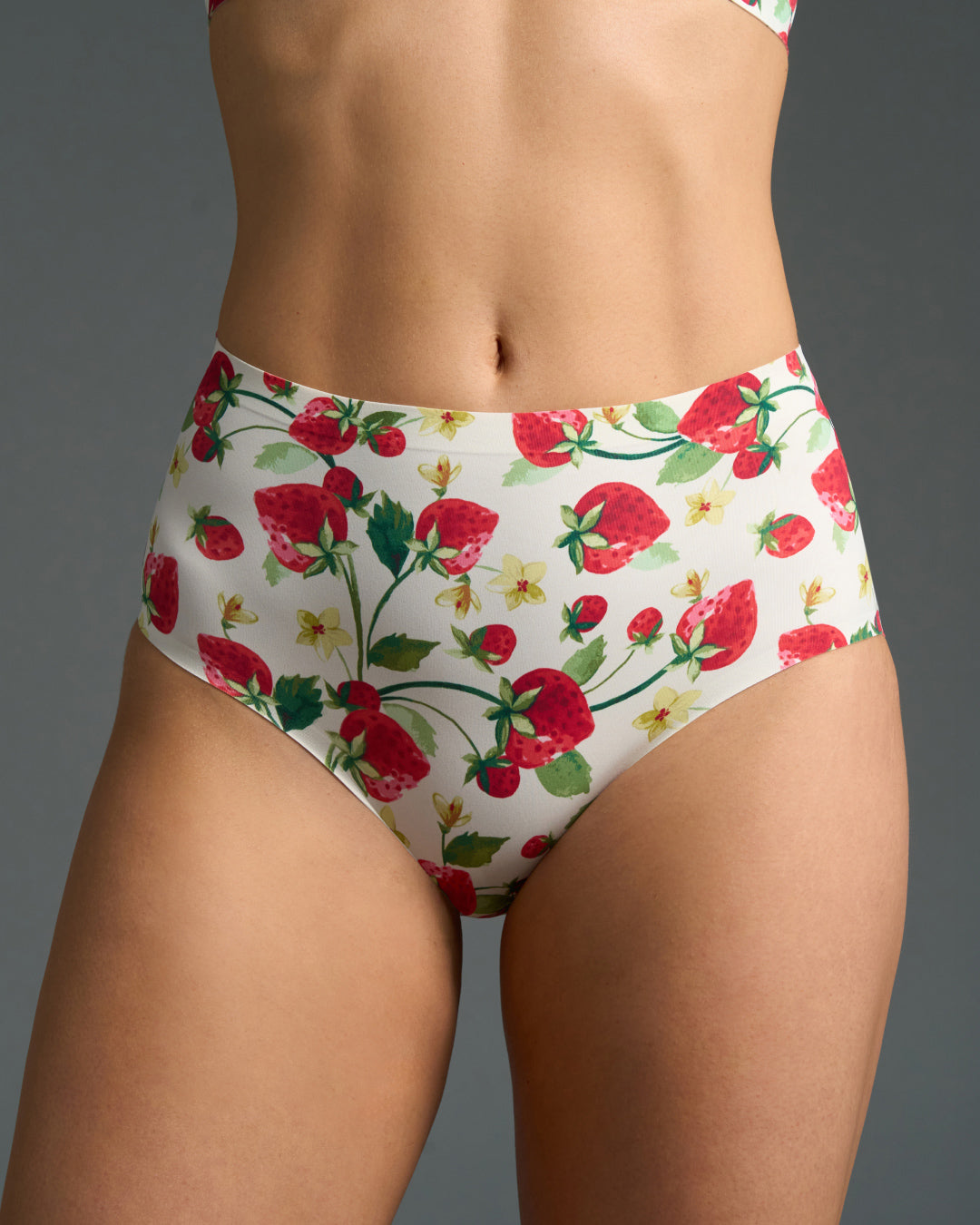 Strawberry patch high rise no show panties shown on model, featuring a white base and seamless edges for invisible comfort under clothing