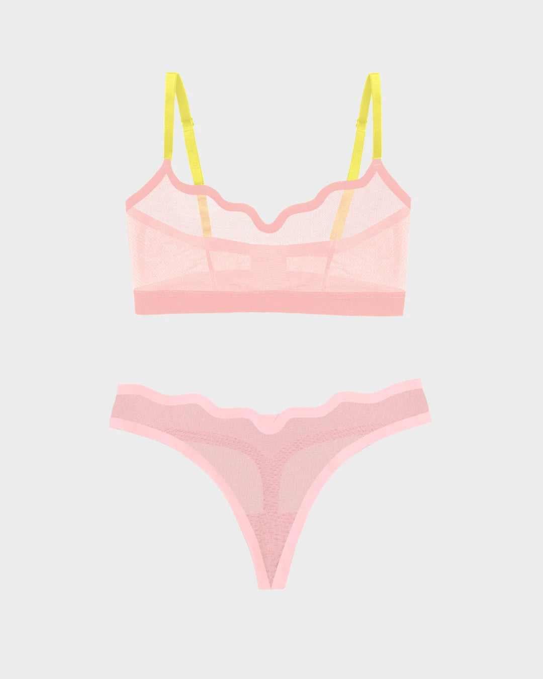 Pink sheer mesh Lucy bralette with yellow straps and matching thong on grey.