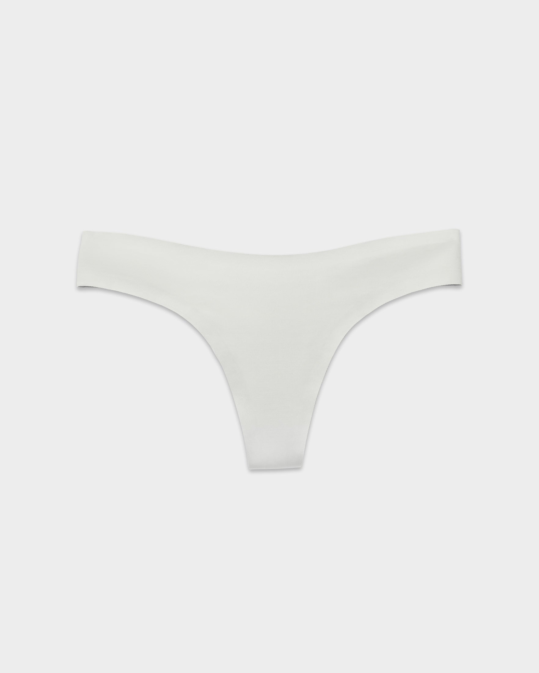 EBY Pearl seamless thong in soft white, laid flat with smooth no-show edges.